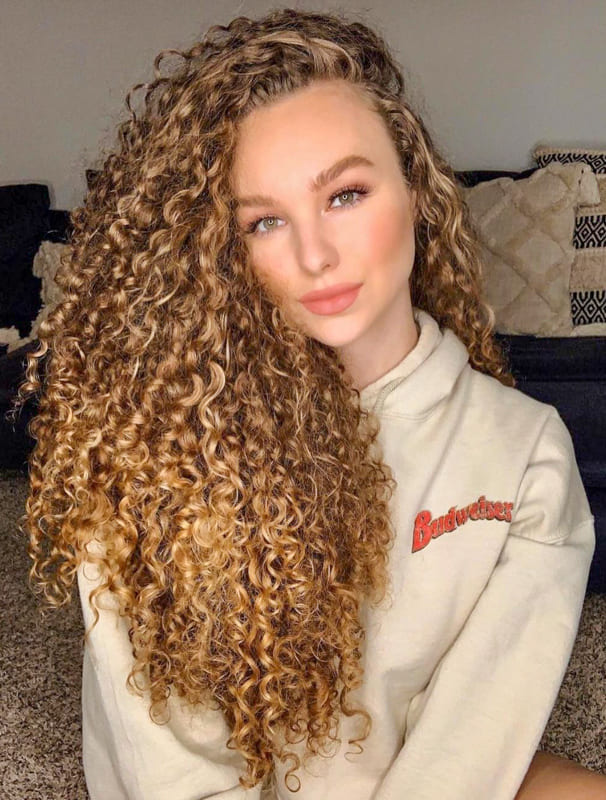 Blonde volumed long curly hair