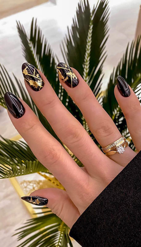 Black and gold almond nails