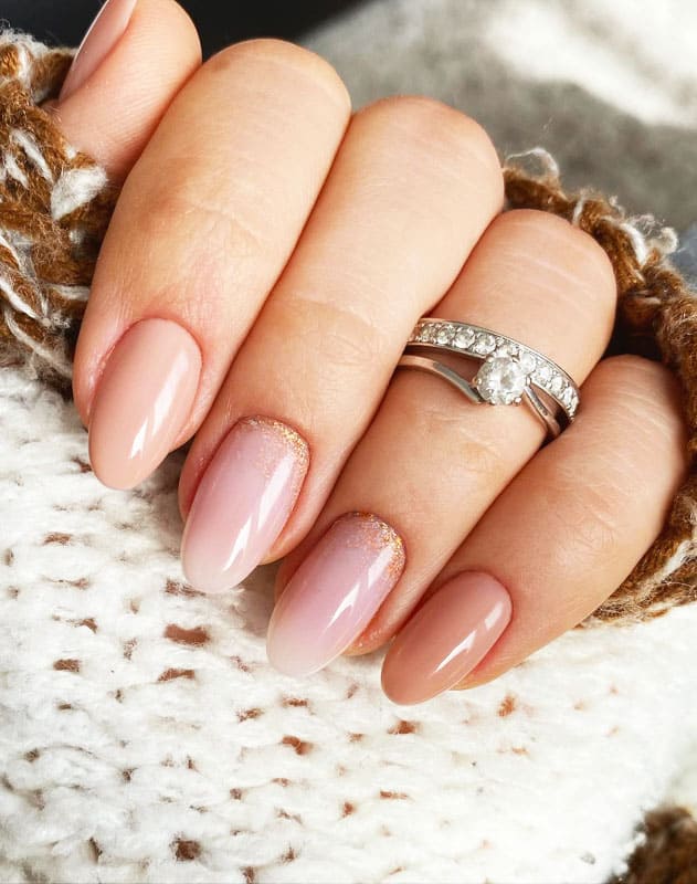 Nude with gold glitter fall nails